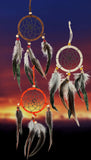 A dream catcher set of three colors: brown, ivory, & orange, and are adorned with complimentary beads and brown/gray feathers.
